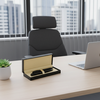 Modern office desk with laptop, stationery, and a chair in front of large windows with cityscape view.